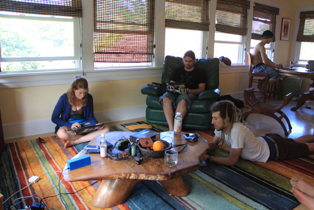 Meskio and others working in the living room at Winter Break of Code