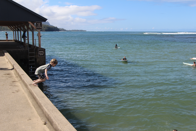 Jumping off the pier at Hanalei Bay